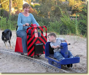 Child and Mother on Hand Crank Cars